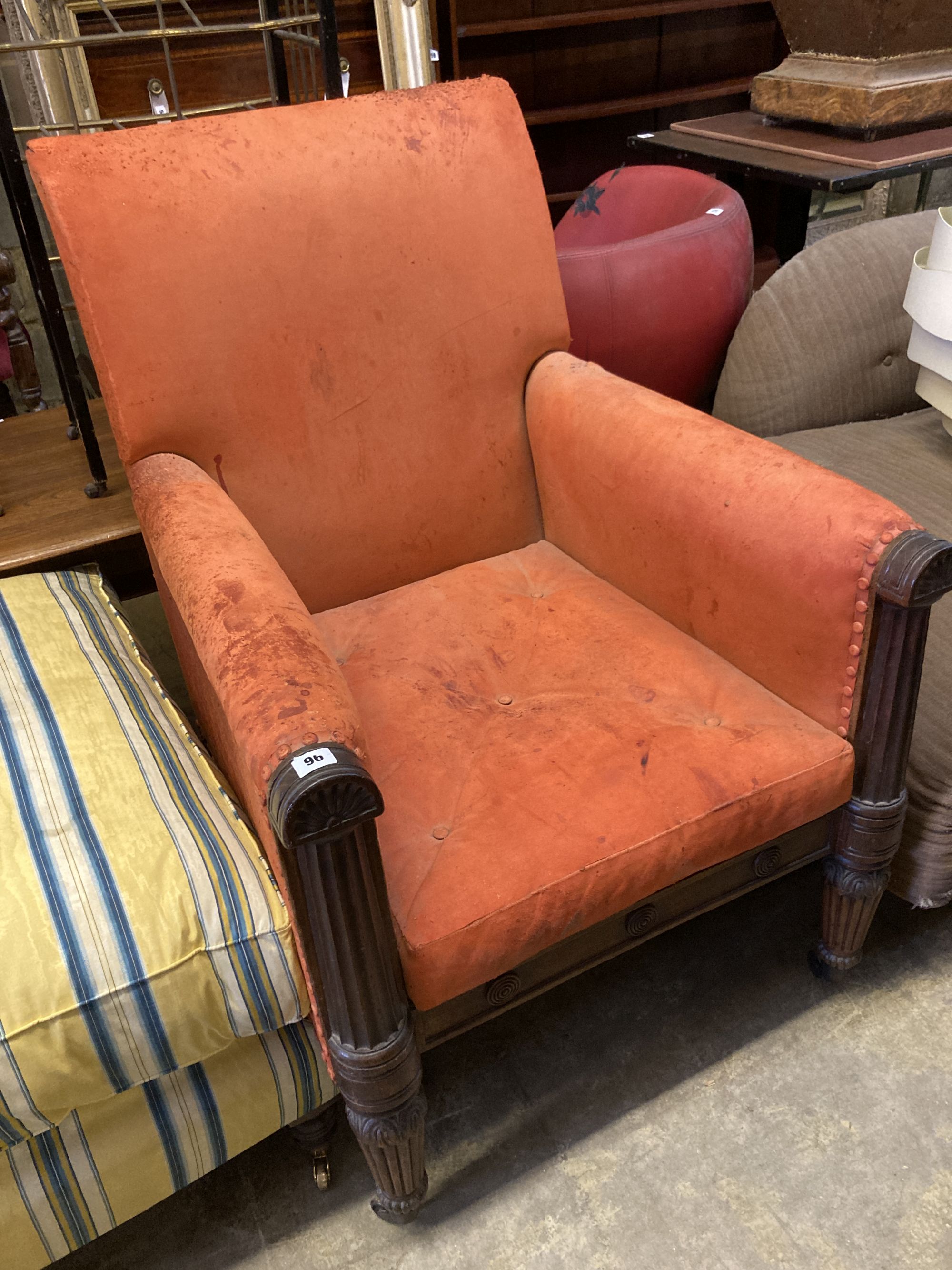 A George IV carved mahogany library armchair upholstered in faded red leather, width 70cm, depth 80cm, height 100cm